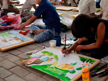 A girl painting at Children's Biennale 